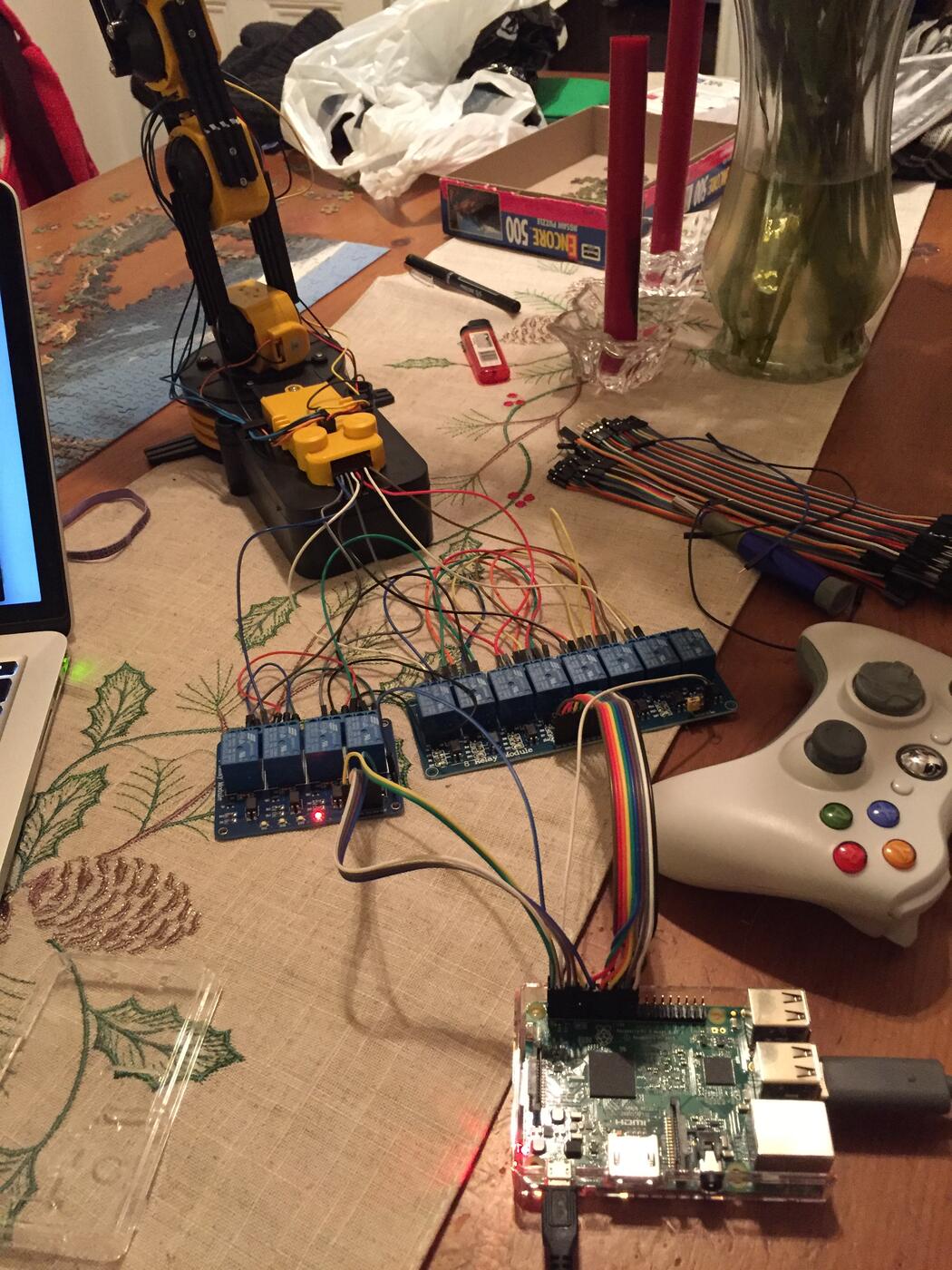 The completed rig: the arm wired through two relay boards to the Raspberry Pi, with the Xbox controller alongside