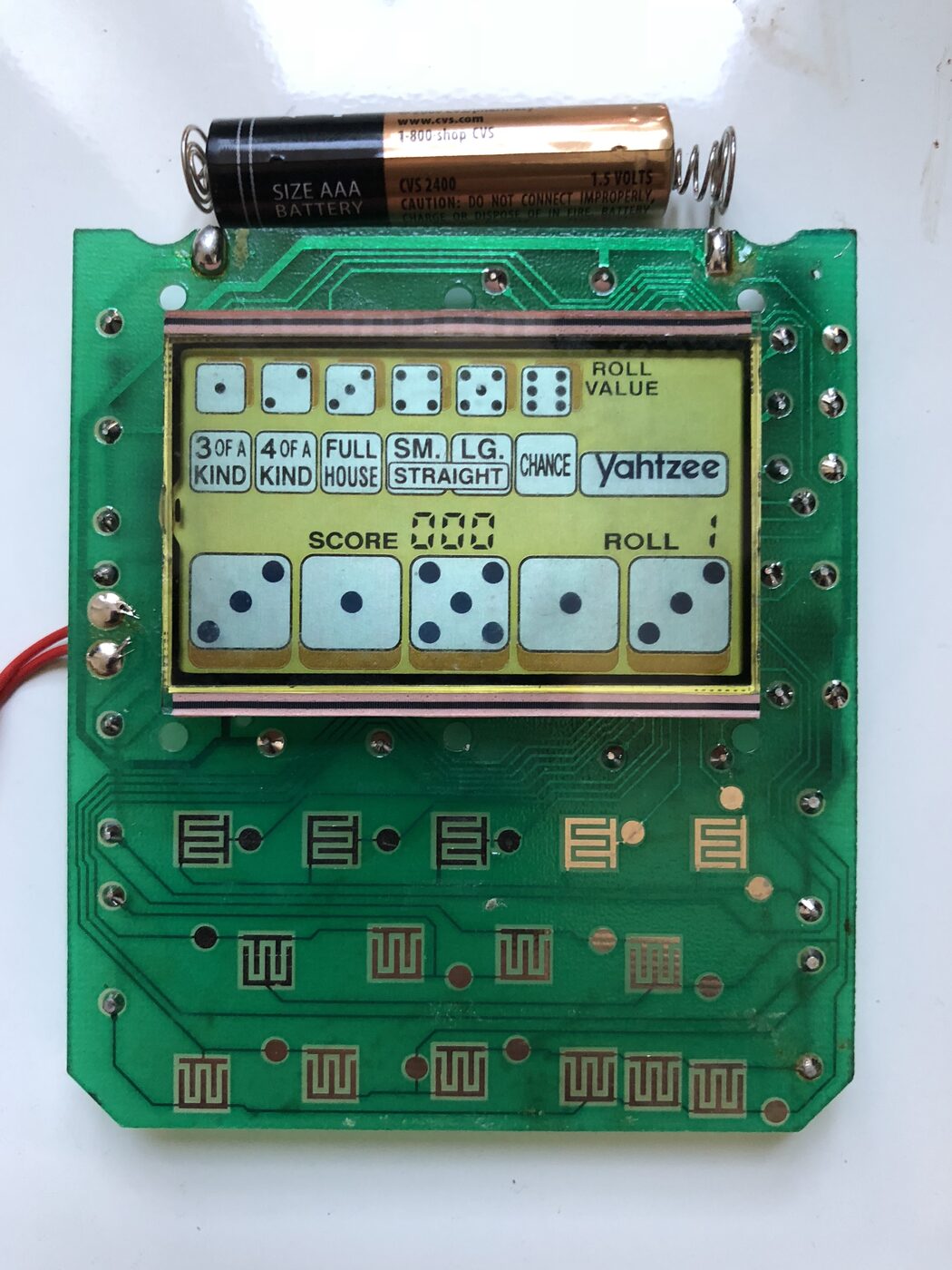 The opened handheld Yahtzee circuit board